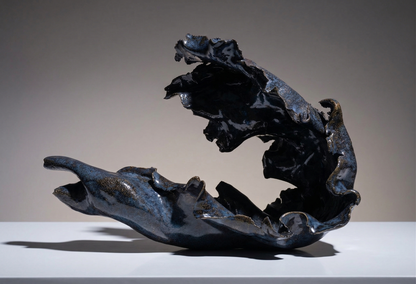 Blue, abstract sculpture on a grey background